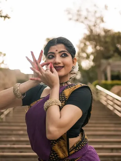 A close-up shot focusing on the 'nasikabhushani' mudra, a hand gesture indicating a nose ring. The detail in our hand gestures, or 'hastas', is crucial for storytelling.