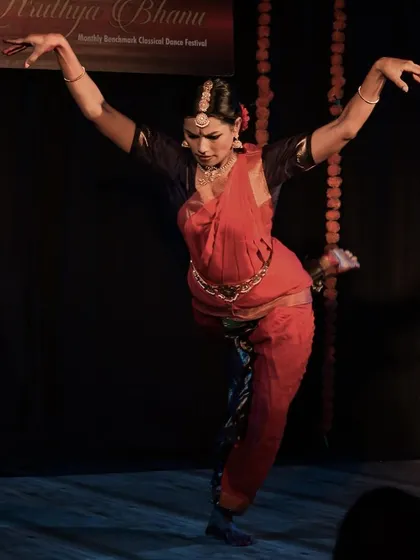 A dynamic pose from Sowmya's performance, showcasing her strength and flexibility.