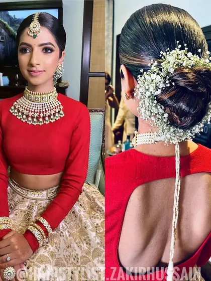 A classic bridal look featuring a sleek bun adorned with a full wrap of baby's breath. This is a timeless and elegant choice for any bride.