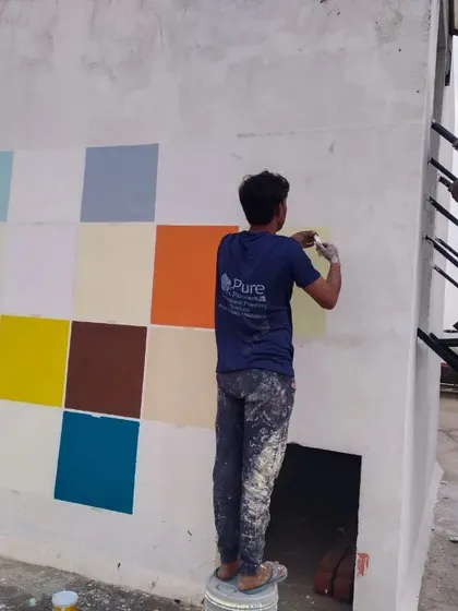 Our team applying different color swatches to an exterior wall. This helps clients visualize and choose the perfect shades for their project before we commit to the final colors.