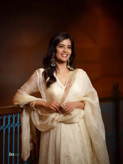 This portrait showcases the full sweep of the Anarkali. The pose is graceful and the smile is radiant, making it a perfect shot for any festive occasion.