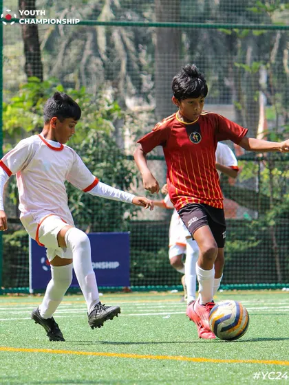 A player controls the ball with precision, looking for the next pass during a competitive game.