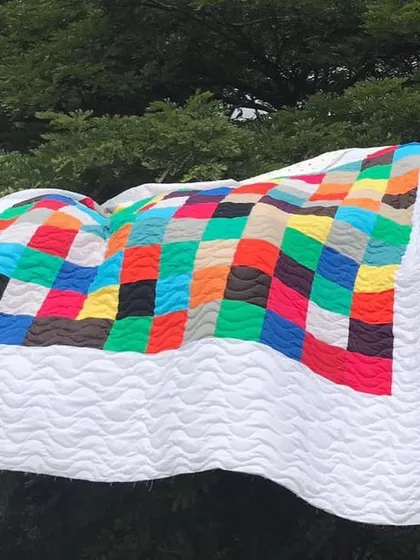 Another view of the modern color-block quilt, waving in the breeze.