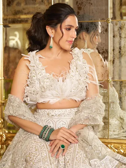 A closer look at the feathered blouse and emerald jewelry. I love adding a pop of contrasting color with accessories to make a monochrome outfit stand out.