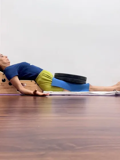 This is a demonstration of a supported Savasana using the Simhasana Box and weights. This restorative setup opens the chest to improve breathing, supports the natural curvature of the spine, and uses gentle weight to ground the body, calming the nervous system and promoting deep relaxation.