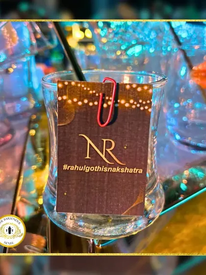 A custom drink tag featuring the couple's hashtag, #rahulgothisnakshatra. It's a simple way to tie the bar experience directly into the wedding's social media presence.