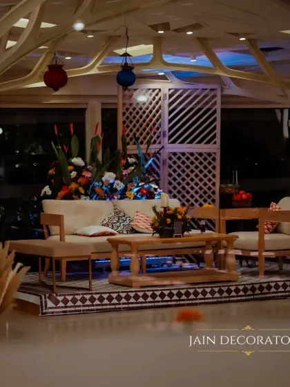 A comfortable and stylish lounge area for guests. The neutral-toned furniture is accented with colorful pillows and lanterns, set against a backdrop of geometric screens for a modern touch.