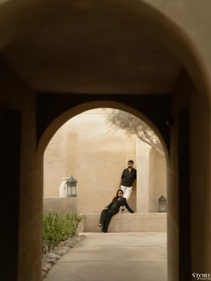 Framing the couple within the beautiful archways of their Dubai location. This technique creates a sense of intimacy and draws the viewer's eye directly to their connection.