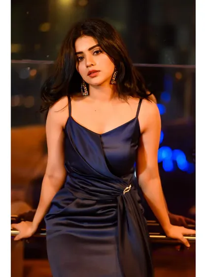 A final, stunning shot of Pavithra Gowda in the navy satin gown. This piece truly embodies the "Red Carpet Studio" spirit of accessible luxury.