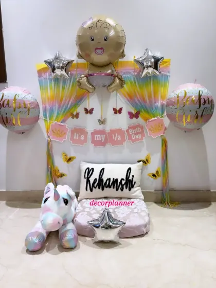 Another view of the adorable half-birthday decor, highlighting the 'It's my 1/2 Birthday' banner and the large baby-shaped foil balloon at the top.