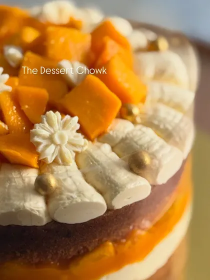 Another detail shot of the mango cake, focusing on the delicate decorations on top.