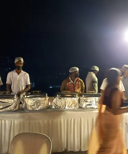 An evening dinner buffet arranged on a client's rooftop. Our team is equipped to handle outdoor catering, ensuring a professional setup with proper food handling and service, no matter the location.