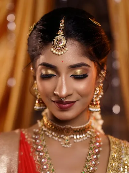 A serene close-up with eyes closed, showing the beautiful shimmer of the golden eyeshadow. The skin looks luminous and healthy.