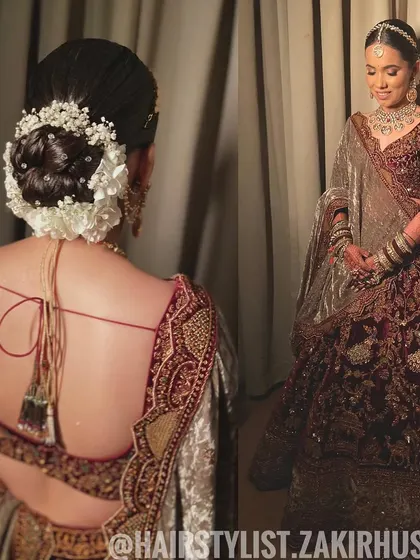 A full-length view of the bride, showing how her classic floral bun complements her velvet lehenga.