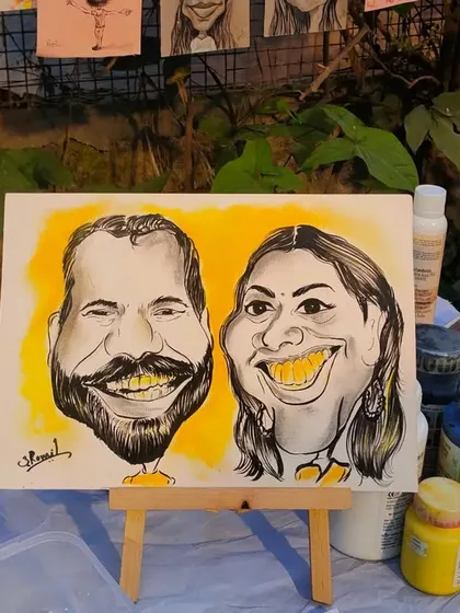 The same couple caricature displayed on a mini easel, showing how it looks as a decorative piece.