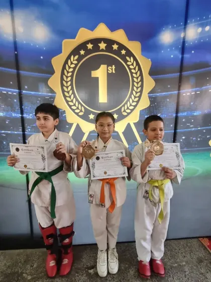 Three young champions standing on the winner's podium. This is a moment they will remember forever.