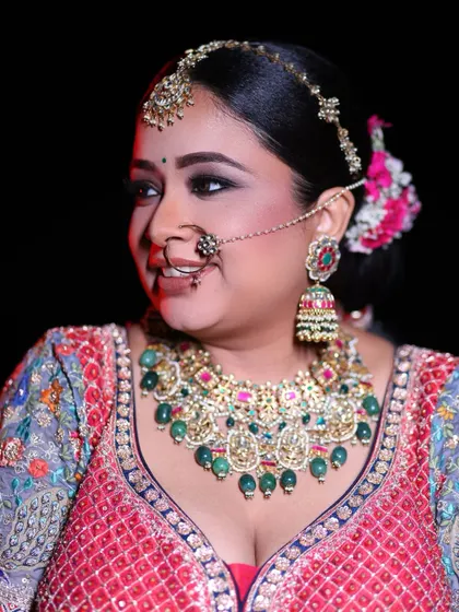A close-up of the bride's stunning jewelry and joyful expression, highlighting the intricate details of her bridal look.