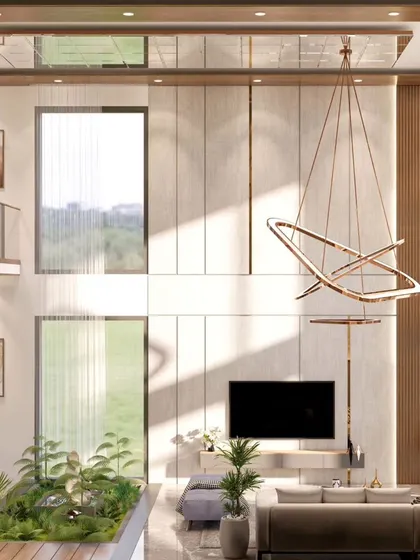 Another view of the North Bangalore villa's living room, showing the bridge overlooking the space and the large, modern chandelier. The design balances grand scale with serene, nature-inspired elements.