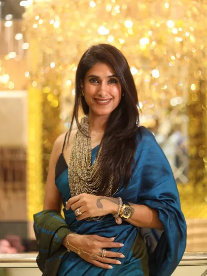 Styling a saree is about expressing your unique personality. Here, I've paired a beautiful blue and green saree with a bold, multi-layered necklace to create a look that is both traditional and modern.
