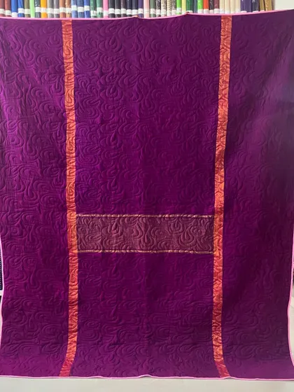 A collection of reversible memory quilts crafted from the sarees of a client's mother. Each side tells a different story, preserving the fabric's patterns and colors in a new, functional form.