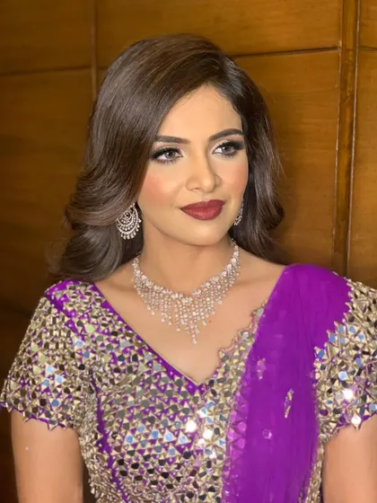 This angle shows the beautiful contrast between the bold lip color and her flawless, glowing skin.
