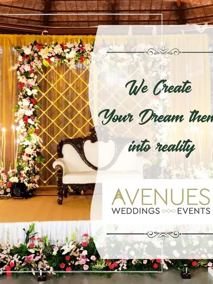 We create your dream theme into reality. This image showcases an elegant stage with a vintage-style white couch and a beautiful floral arch against a golden lattice backdrop, perfect for a classic wedding.
