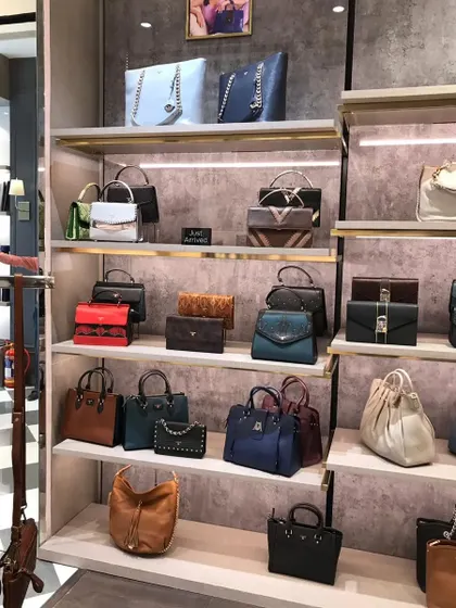 Another angle of the handbag display wall, demonstrating the high density of product that can be shown in an organized and appealing way.
