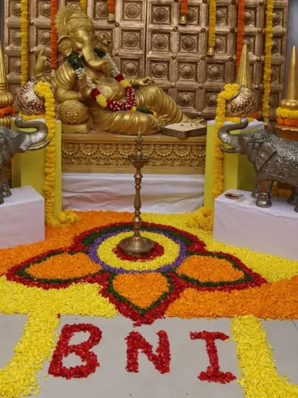 This is an example of decor for a corporate event with a traditional theme. For this BNI meet, I created a grand Ganesha installation with a detailed floral rangoli on the floor, combining professional branding with cultural elements.