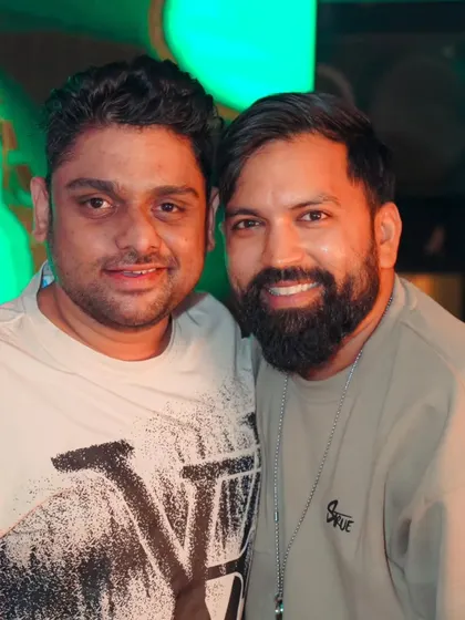 Posing for a photo with a friend and fellow artist at the club. The music industry is built on these connections and friendships.