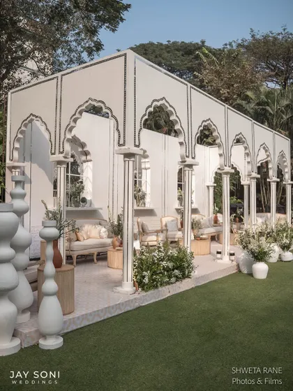 A long shot of the architectural lounge structure, showing how the repeating arches create a beautiful, semi-enclosed space for guests to gather.