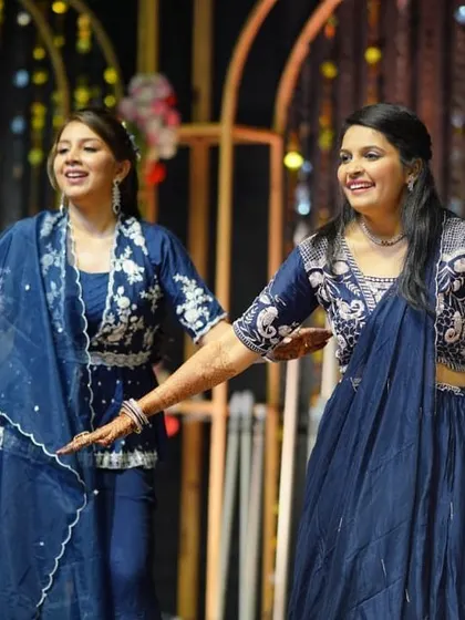 Sisters performing a graceful duet for their sibling's wedding. We work with smaller family groups to create polished and emotional performances that add a personal touch to the sangeet.
