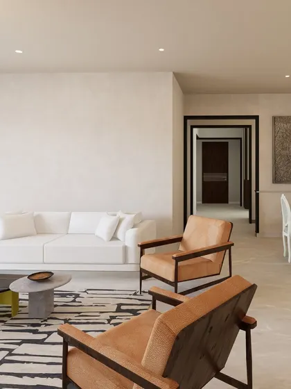 A closer look at the seating arrangement in the Jayanagar residence proposal. The design uses a mix of a plush white sofa and structured leather armchairs to create a balanced and comfortable living space.