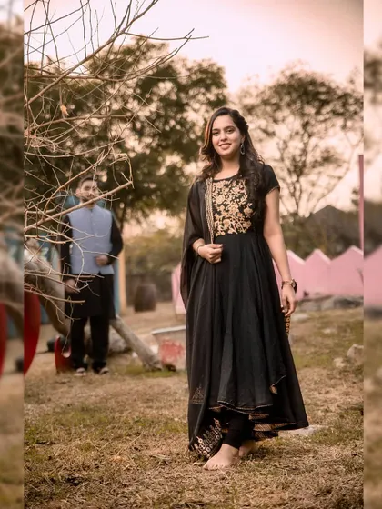 A full-length portrait of the bride-to-be in her elegant black Anarkali. This shot from their pre-wedding session showcases her grace and style.