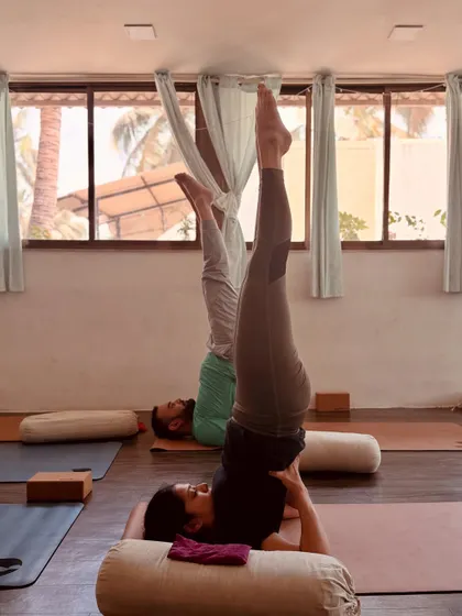 Exploring supported inversions like Viparita Karani during the Yoga Sangraha workshop. We use props like bolsters to help the body relax completely and receive the full restorative benefits of the pose.