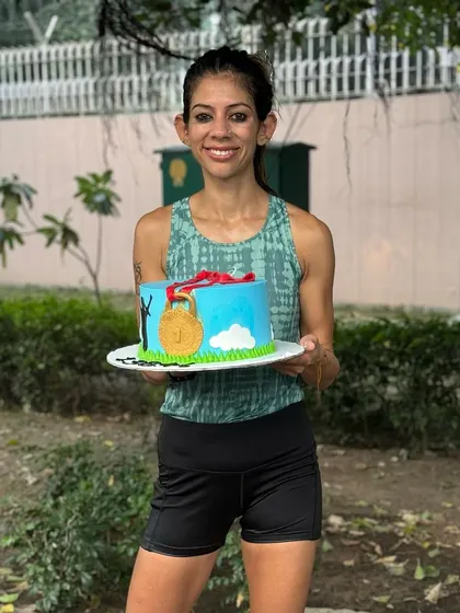 Celebrating a gold medal win at the Vedanta Delhi Half Marathon with a custom cake. It's important to acknowledge and celebrate milestones with the community that supports you.