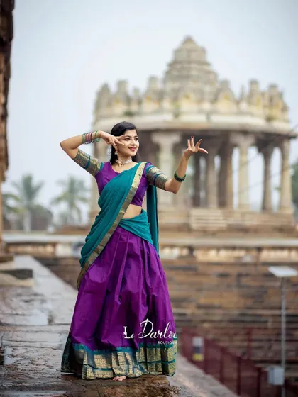 A series of photos from a collaboration with a designer, showcasing a beautiful half-saree against the backdrop of ancient temple pillars. I love how the vibrant colors of the costume stand out.
