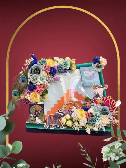 Festivals are all about vibrant joy, and I love creating hampers that reflect that. This Teej hamper is a burst of colour, featuring a peacock motif, rich peacock feathers, and a multi-hued floral design to pack sarees and gifts with a festive spirit.