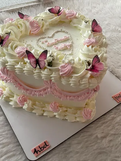 Another angle of the vintage butterfly heart cake, showing the layers of buttercream frills.