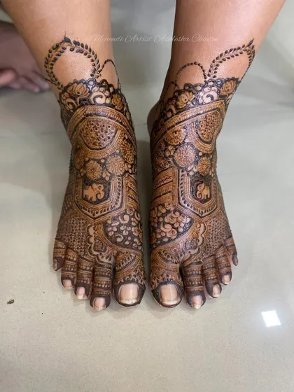 Another angle of the intricate bridal feet design. The patterns are a mix of traditional motifs, creating a timeless and elegant look.