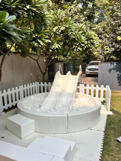 A close-up of our popular white ball pit with a dual slide. It's a perfect standalone feature for smaller spaces or a great addition to a larger play zone.
