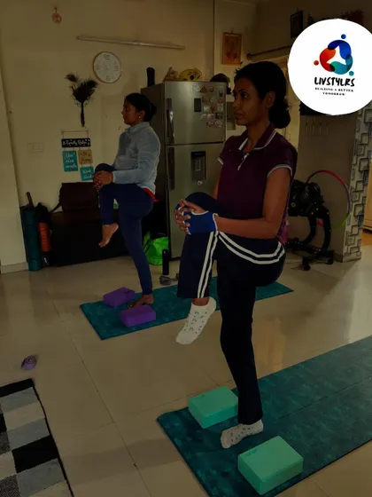 Two young clients practice balancing on one leg, an exercise that improves focus and stability.