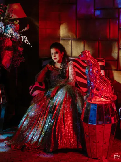 A dramatic portrait of the bride in a red-lit corner, looking like a star from a classic film.
