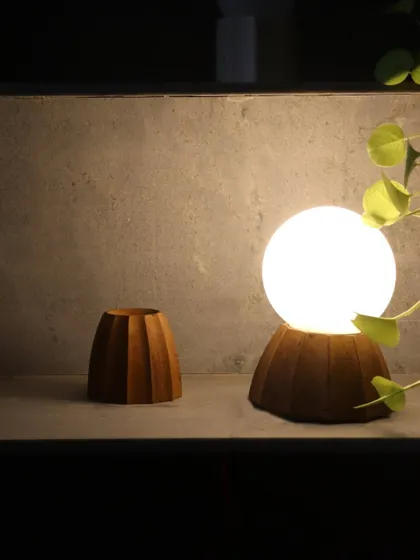 A collection of our custom light fixtures, showing variations in wood and marble bases. Each piece is designed as a small sculpture, contributing to the overall aesthetic and atmosphere of the space.