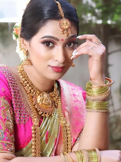 A classic South Indian bridal makeup look. This features bold, defined eyes, a traditional lip color, and a flawless base, paired with heavy gold temple jewelry. This is a look I teach in my pro course.