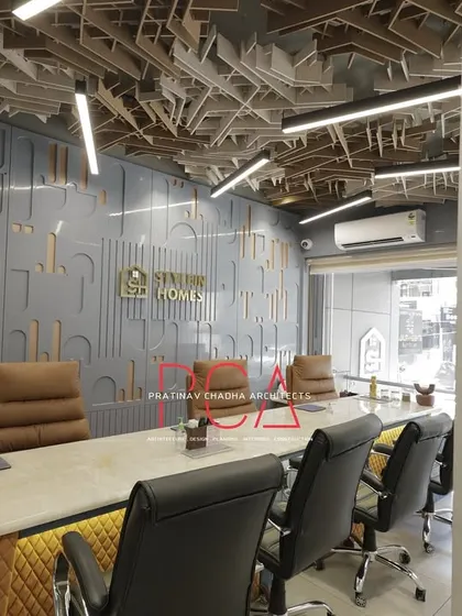 The StyleIn Homes conference room, focusing on the branded feature wall and the executive seating, designed to reflect the company's professional image.