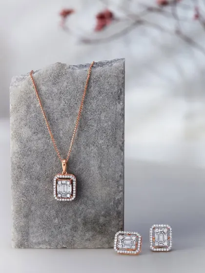 A minimalist composition featuring a diamond pendant and earring set from Orra. I used a simple stone prop and a soft, out-of-focus background to create a serene and sophisticated mood.