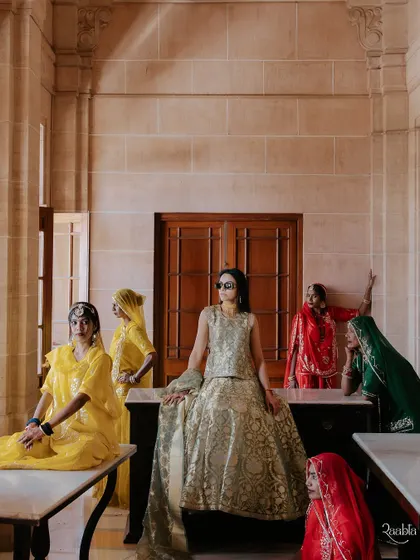 An editorial shot of the bride with local Rajasthani women, creating a powerful and stylish image that blends tradition with modern fashion.