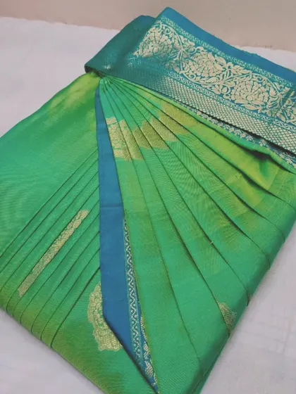 A beautiful sea green saree with a gold border. It's pre-pleated and box-folded, ready for you to wear or travel with.