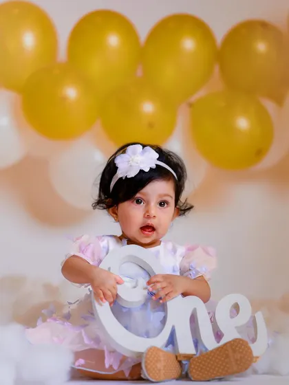 Holding on to being ONE. We use props to add a special touch to our first birthday photoshoots.