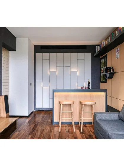 A completed residential lounge room featuring a custom-designed bar unit. This project shows how we integrate functional bar areas into home interiors, using materials like hardwood flooring and unique wall paneling to create a perfect vibe.